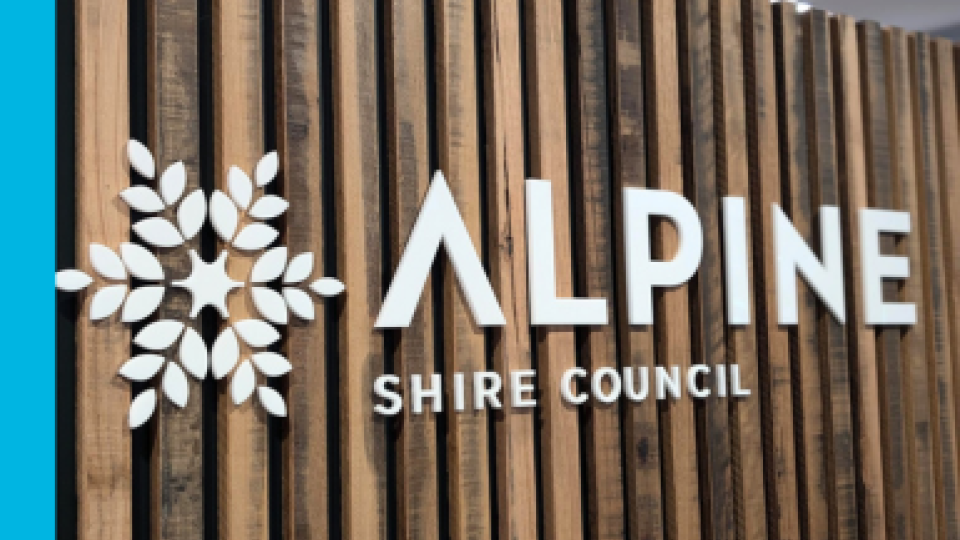 Alpine Shire Council's logo on a timber wall